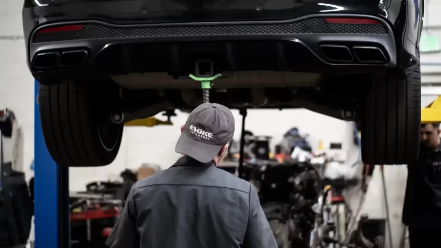 Technician working on car in shop in Englewood, CO.